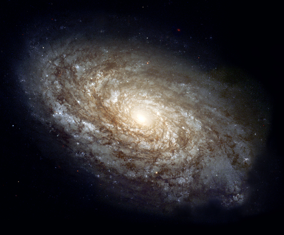In 1995, the majestic spiral galaxy NGC 4414 was imaged by the Hubble Space Telescope as part of the HST Key Project on the Extragalactic Distance Scale. An international team of astronomers, led by Dr. Wendy Freedman of the Observatories of the Carnegie Institution of Washington, observed this galaxy on 13 different occasions over the course of two months. Images were obtained with Hubble's Wide Field Planetary Camera 2 (WFPC2) through three different color filters. Based on their discovery and careful brightness measurements of variable stars in NGC 4414, the Key Project astronomers were able to make an accurate determination of the distance to the galaxy. The resulting distance to NGC 4414, 19.1 megaparsecs or about 60 million light-years, along with similarly determined distances to other nearby galaxies, contributes to astronomers' overall knowledge of the rate of expansion of the universe. In 1999, the Hubble Heritage Team revisited NGC 4414 and completed its portrait by observing the other half with the same filters as were used in 1995. The end result is a stunning full-color look at the entire dusty spiral galaxy. The new Hubble picture shows that the central regions of this galaxy, as is typical of most spirals, contain primarily older, yellow and red stars. The outer spiral arms are considerably bluer due to ongoing formation of young, blue stars, the brightest of which can be seen individually at the high resolution provided by the Hubble camera. The arms are also very rich in clouds of interstellar dust, seen as dark patches and streaks silhouetted against the starlight. ID: GPN-2000-000933 Other ID: PR99-25